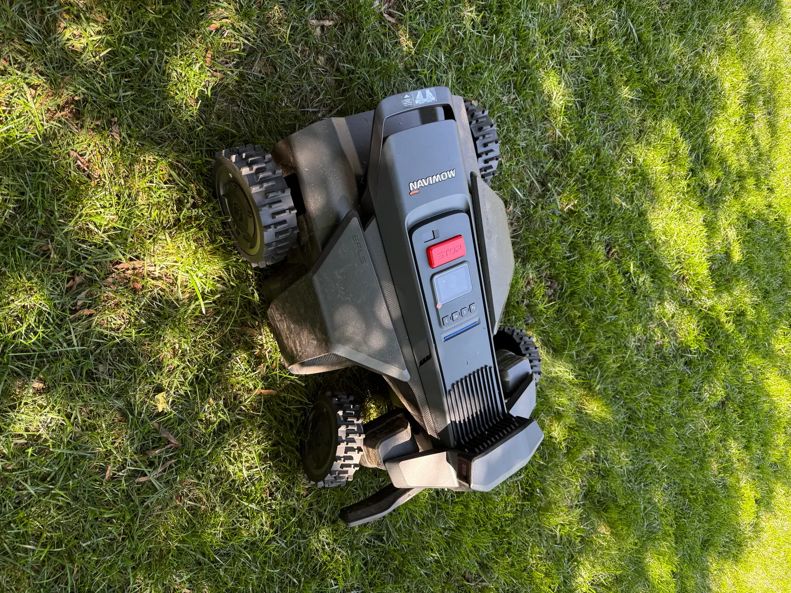 Segway Navimow X430 robotic mower deployed on a residential lawn — top-down view showing the 17-inch dual-deck cutting system and 4WD Xero-Turn wheels